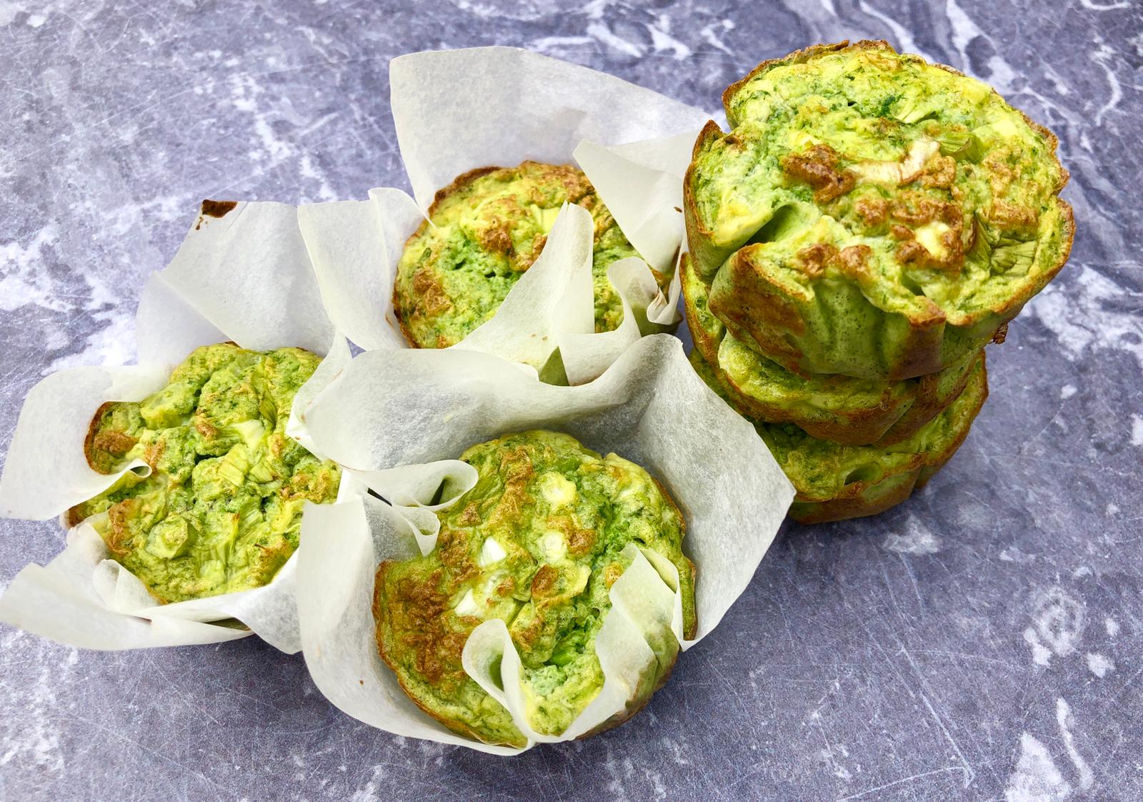 Spinach, pea & spring onion egg muffins, some wrapped in baking paper and some stacked without