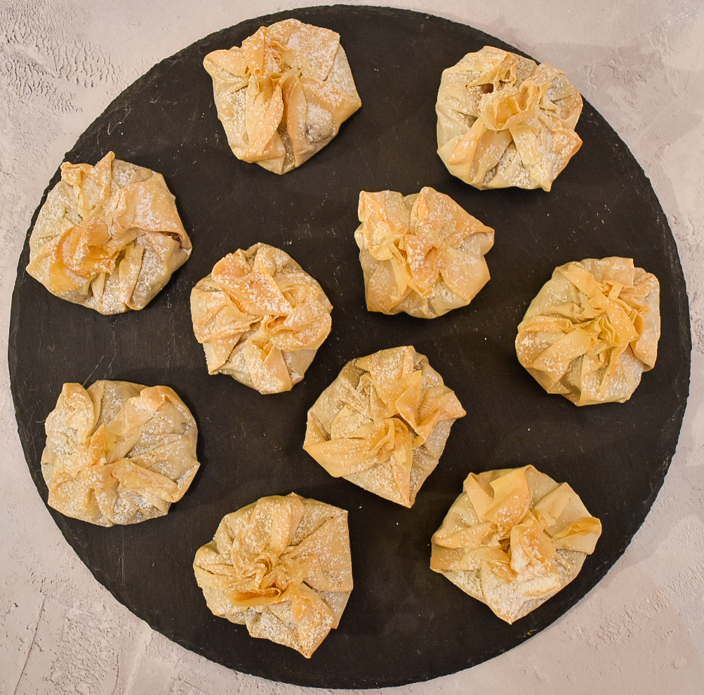 Baked filo mince pie parcels served on a slate chopping board