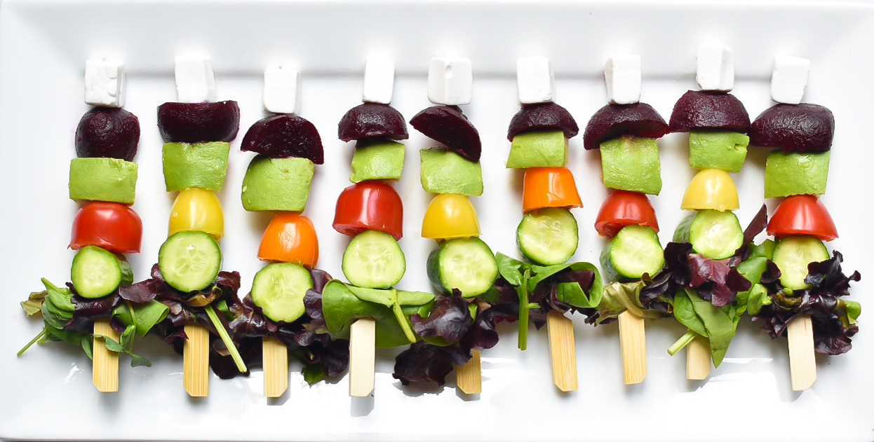 Plate of salad skewers with feta cubes, beetroot, avocado, tomato, cucumber and lettuce