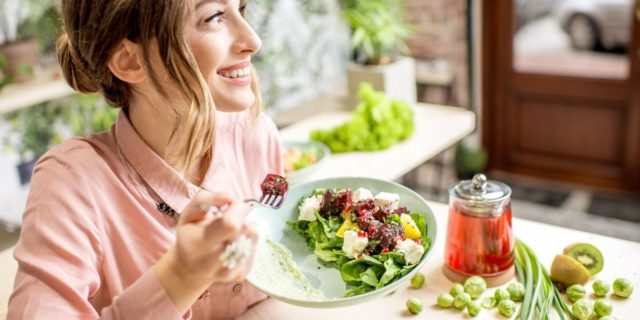 woman eating vegan salad