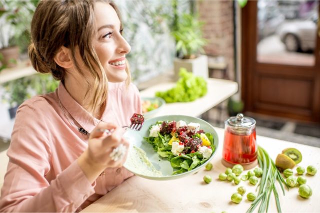 woman eating vegan salad