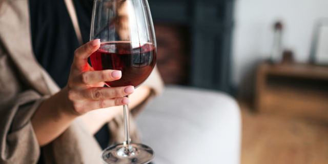 woman holding a glass of red wine