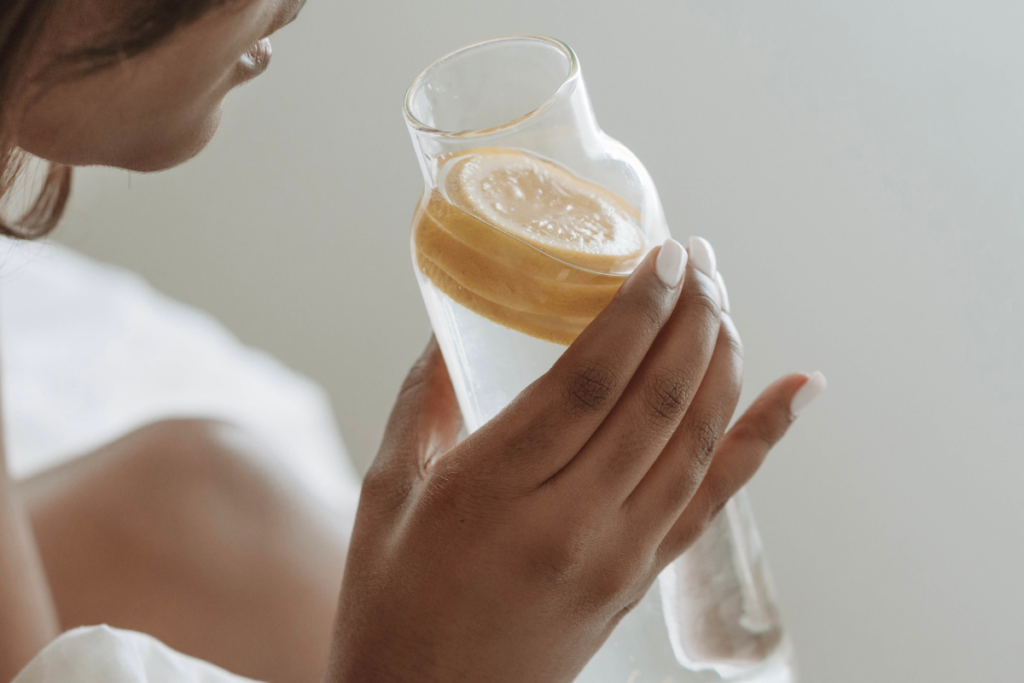 woman drinking water with lemon