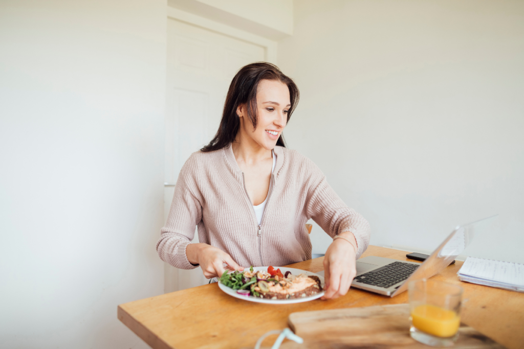 woman eating lunch whilst working