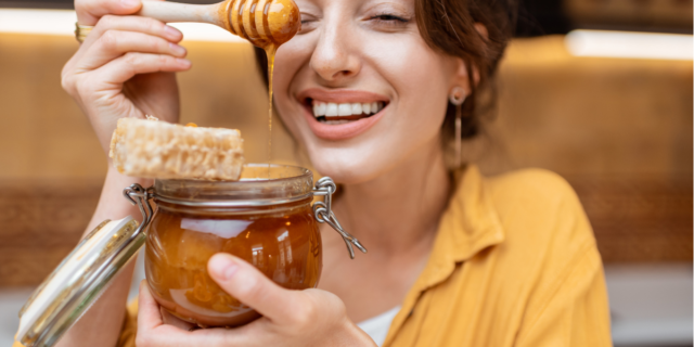 woman holding a honey jar