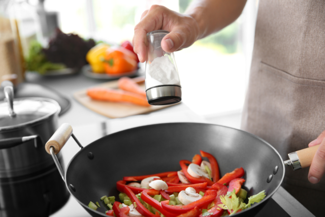 blog images (2) person adding salt whilst cooking a meal