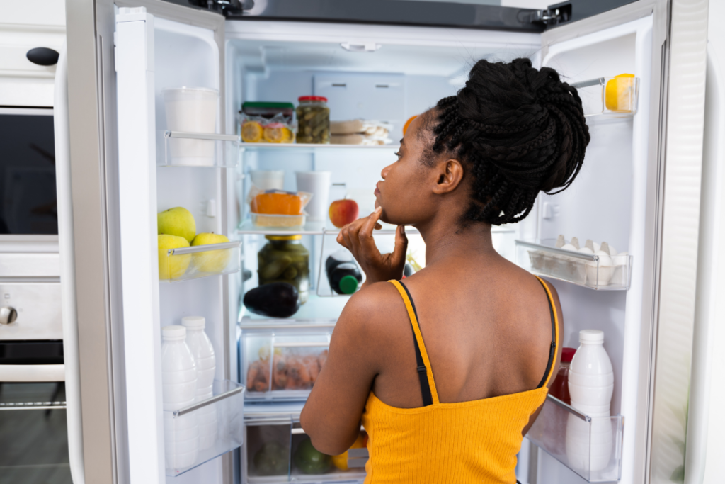 woman looking into fridge