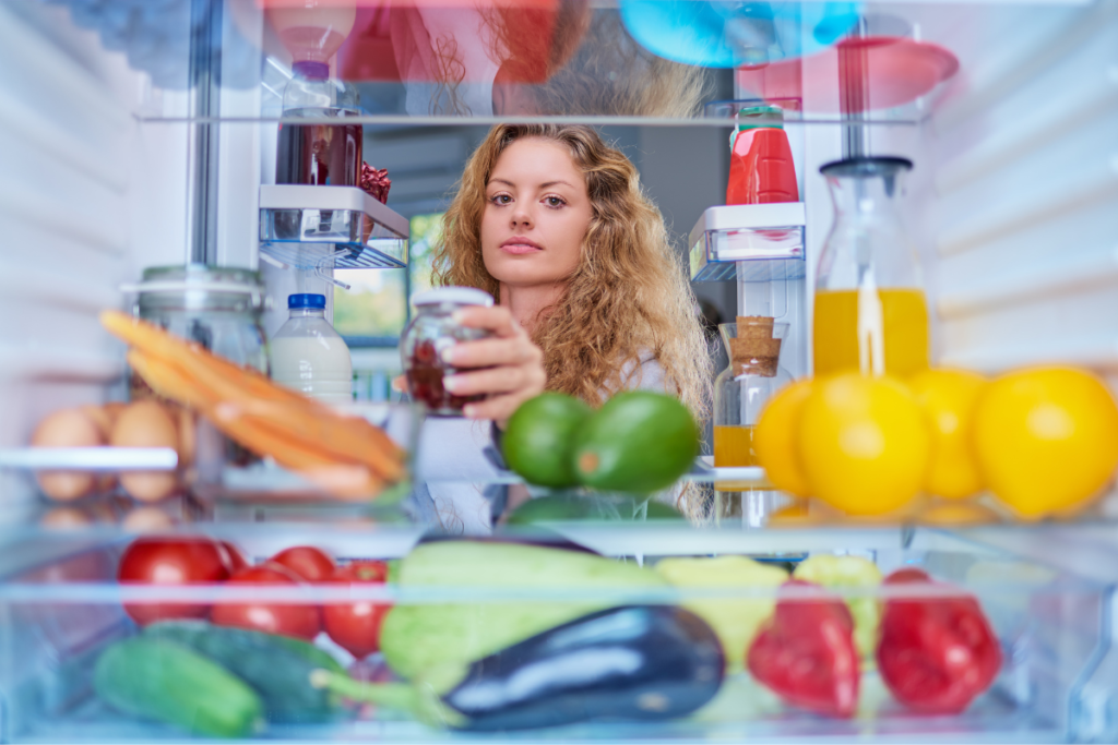 woman taking food from fridge