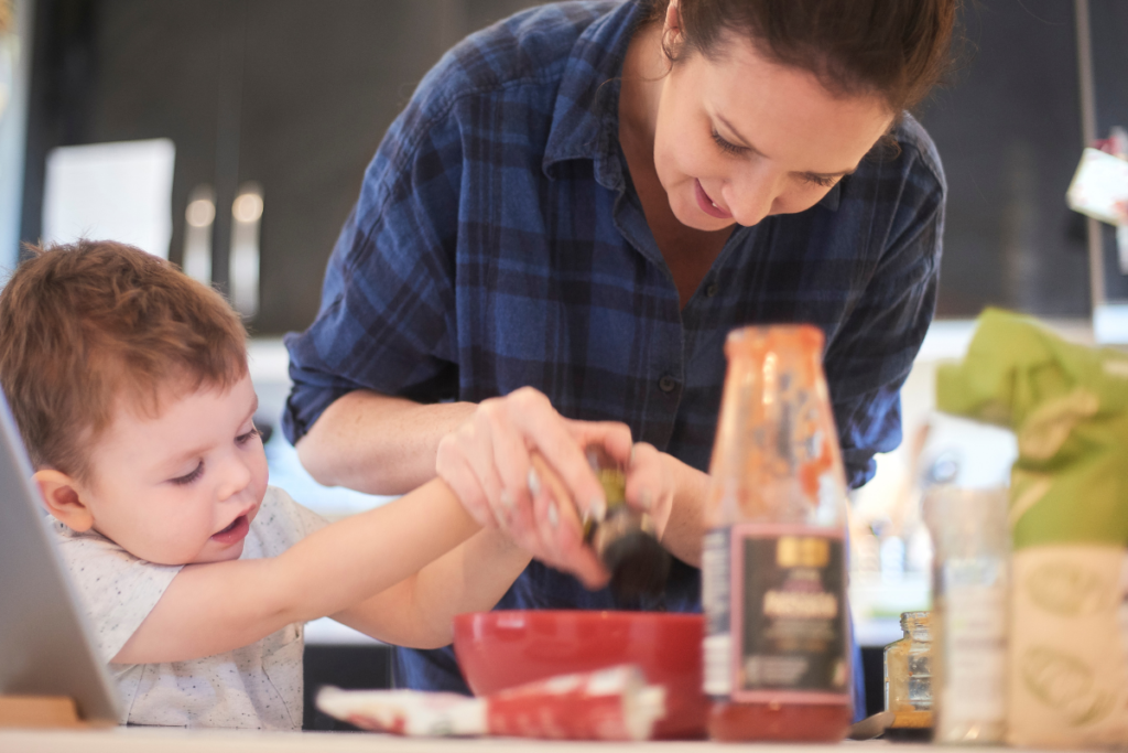 mother and toddler measuring out ingredients while cooking in the kitchen