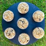 Banana, apple and blueberry muffins served on a slate chopping board